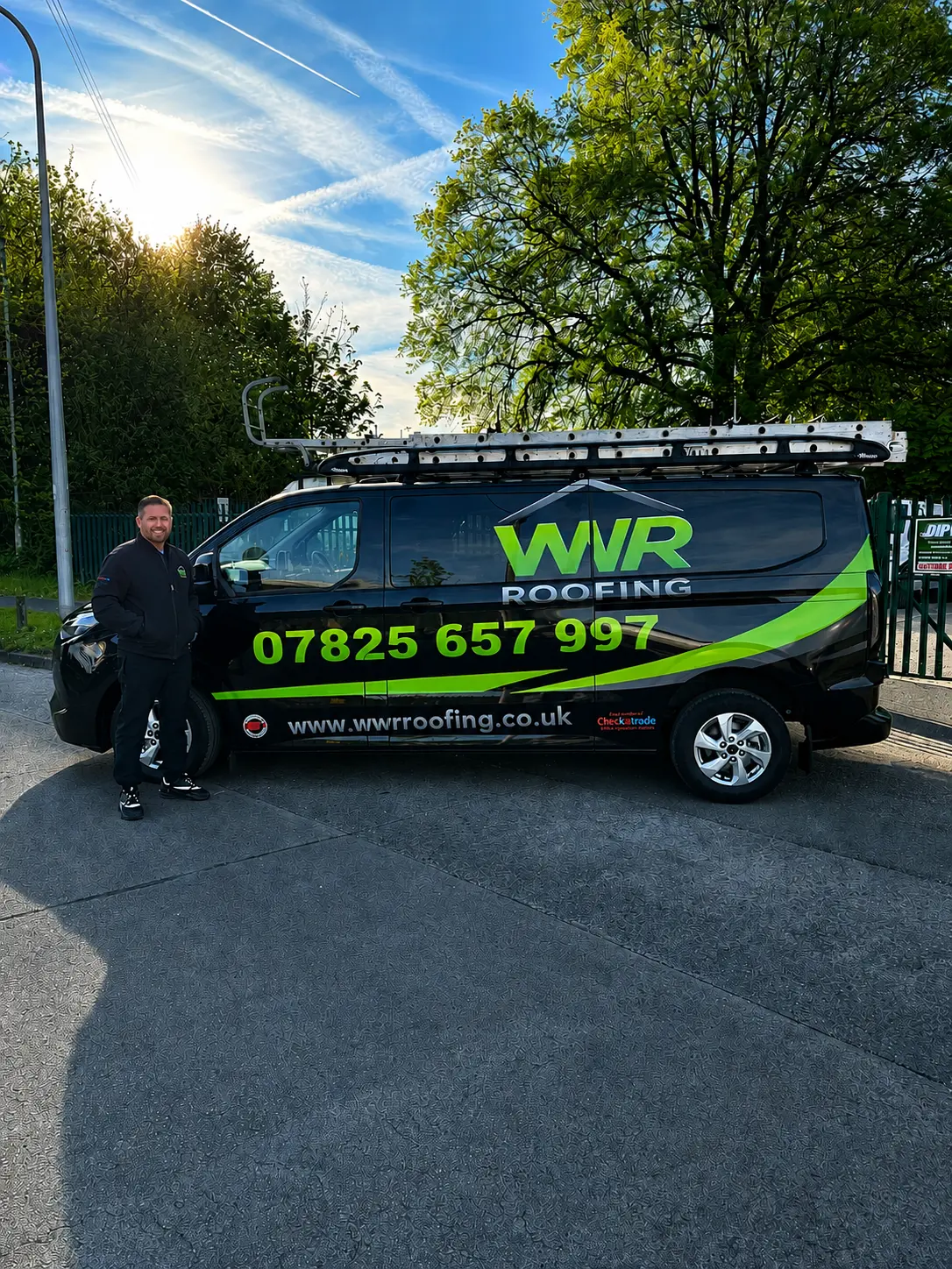 John Edwards, owner of WWR Roofing, beside the company van